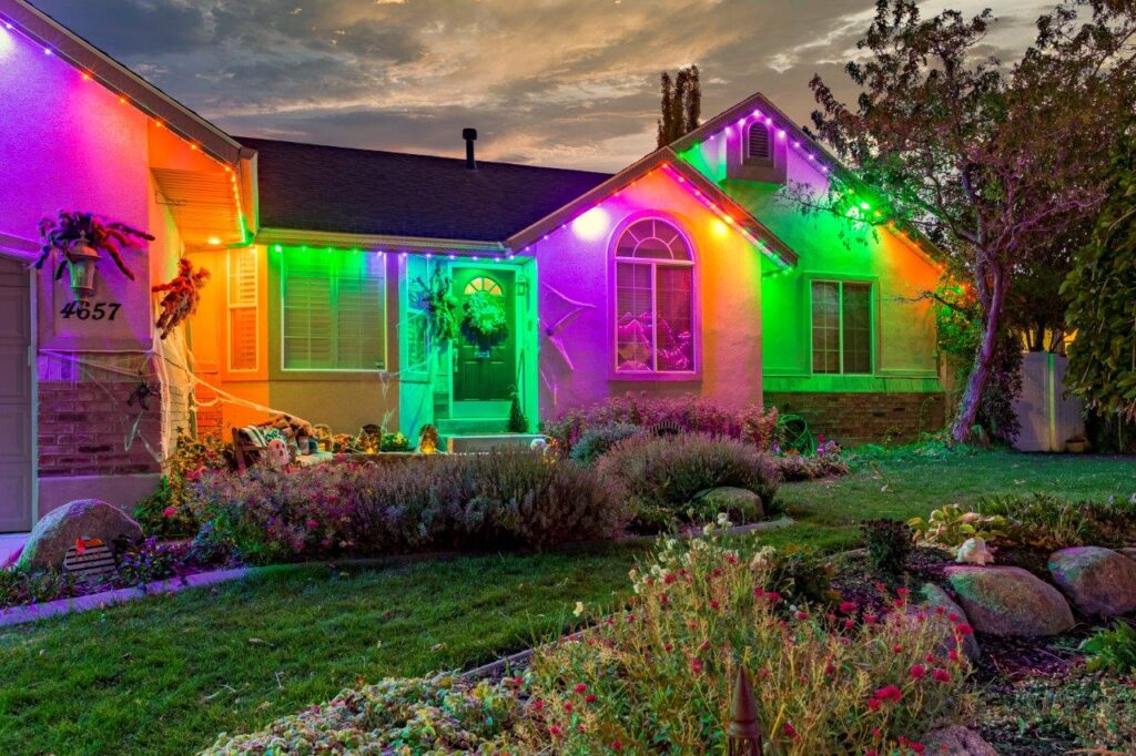 Home lit up with colorful trimlight. Advantages of permanent home trimlight concept image.